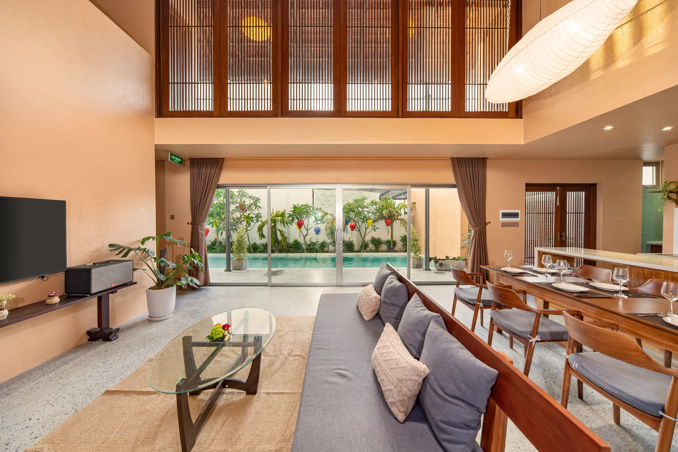 Double-height lounge opening onto the private pool