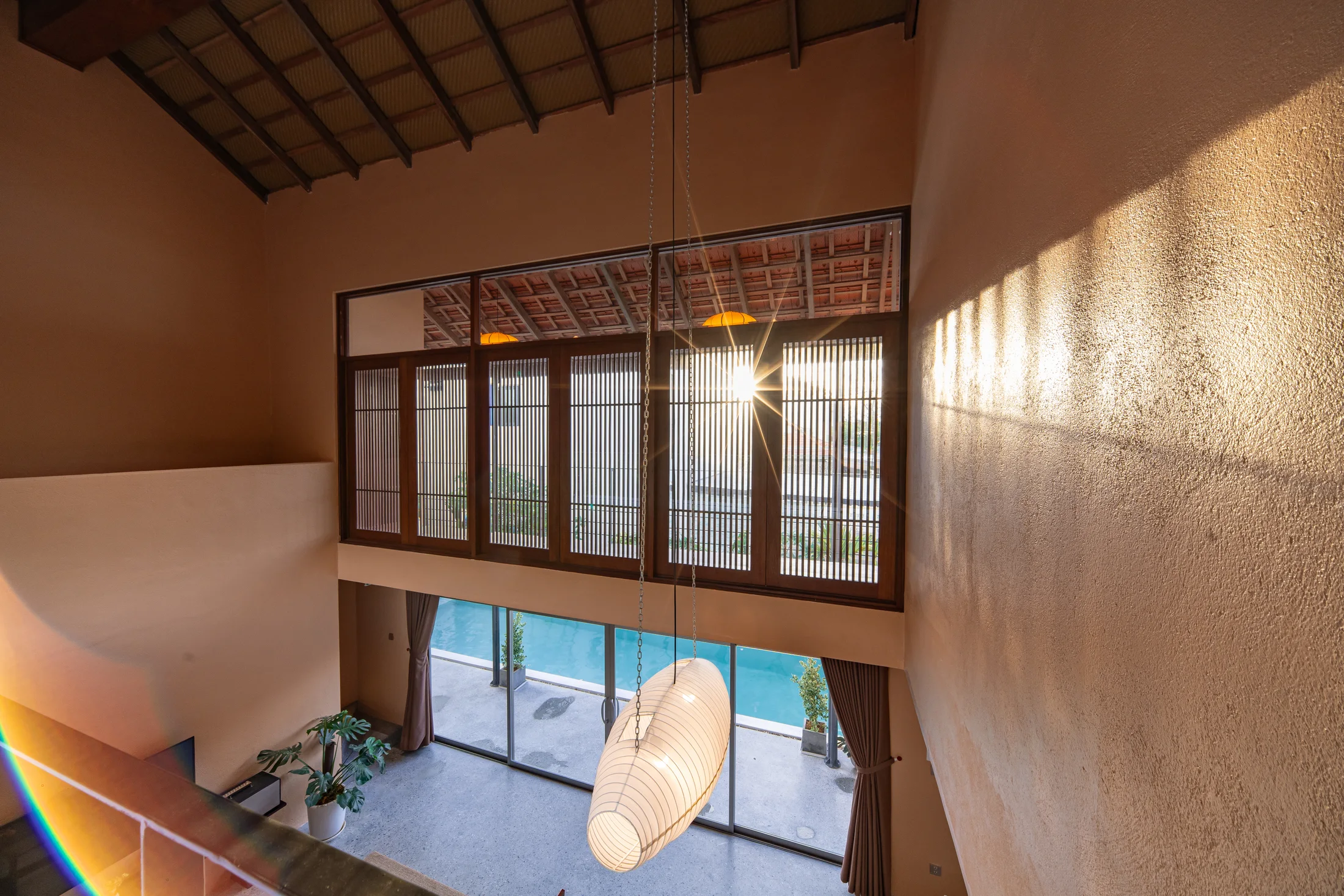 Warm sun across the villa’s timber-lined upper gallery