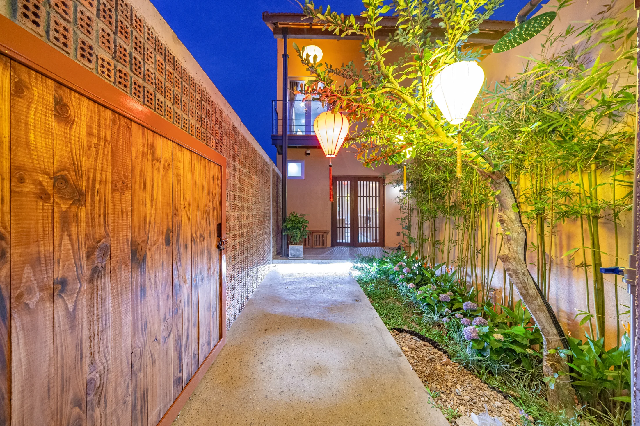 Lantern-lit entrance and tropical garden at Sand Gem Villa