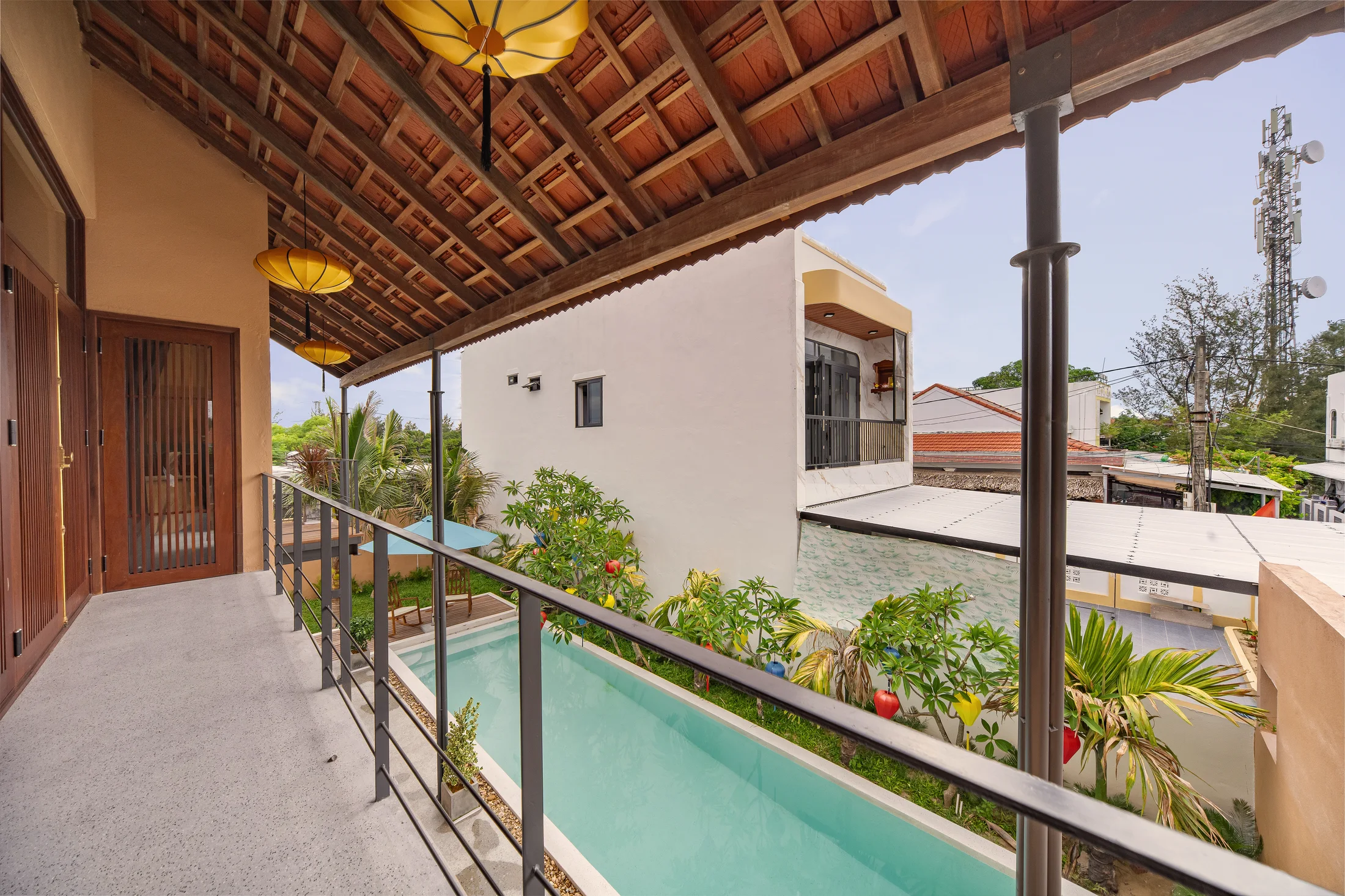 Lantern-hung balcony overlooking the villa pool